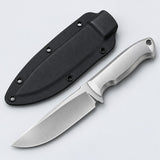 Silver steel fixed blade knife with its black sheath centered on a pale silver studio backdrop.