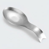 A stainless steel spoon with a decorative, curved handle and a small notch on the end, shown on a light gray background.