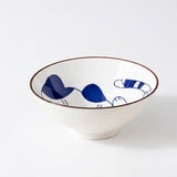 Empty white ceramic bowl with a blue cat illustration, brown rim, and ridged exterior sits against a white background.