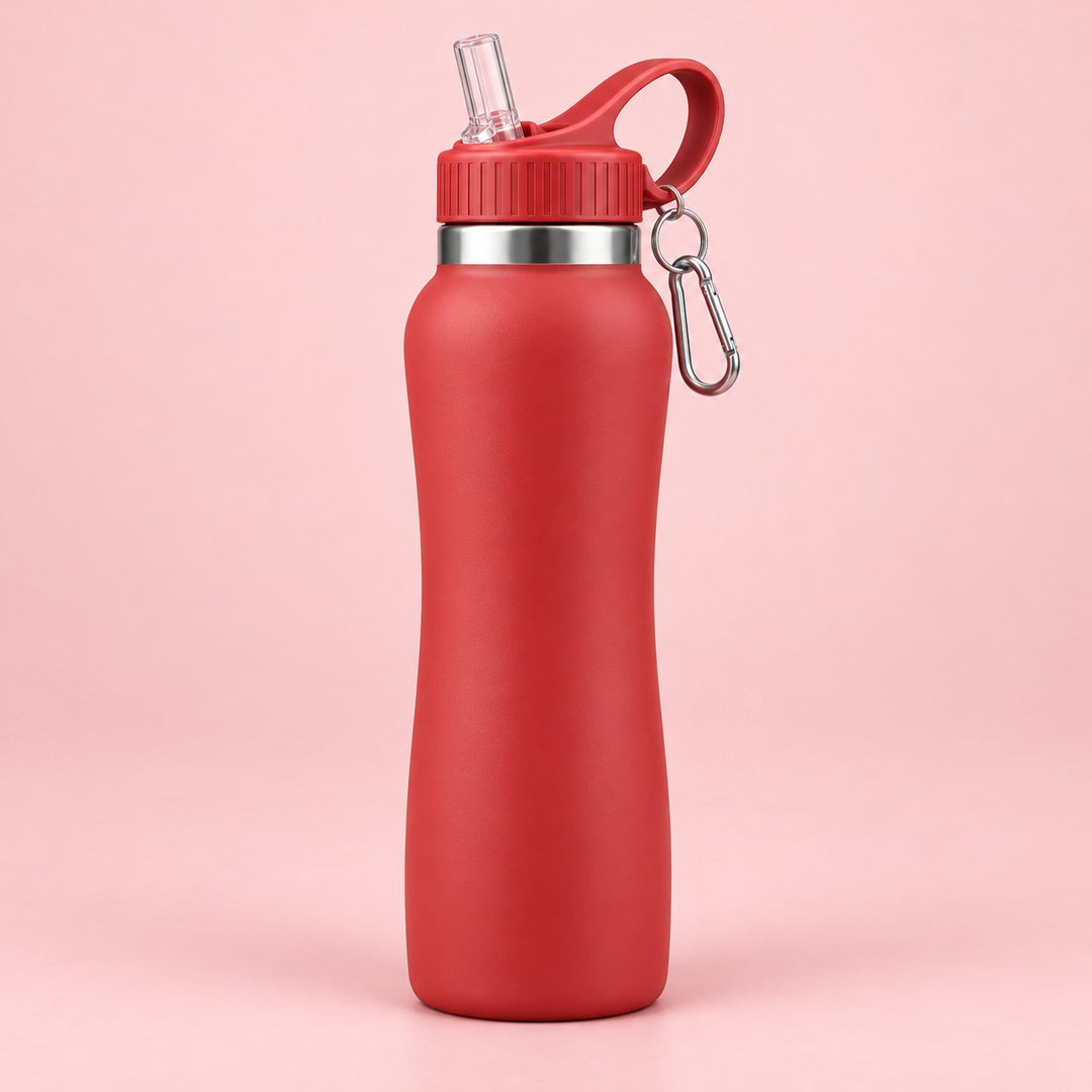Red insulated straw bottle centered on a pale red studio background with its attached carabiner.