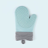 A single quilted oven mitt in a light mint green color with a textured diamond pattern on the palm side and a solid gray fabric cuff at the bottom, shown against a plain light blue background.