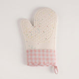 A quilted oven mitt with a white top half featuring a subtle multicolor sprinkle pattern, and a pink and white gingham checkered bottom cuff with a hanging loop, shown on a plain white background.