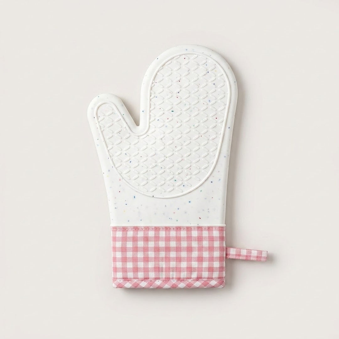 A quilted oven mitt with a white textured top half and a pink and white gingham checkered bottom cuff, shown on a light beige background.