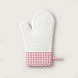 A quilted oven mitt with a white textured top half and a pink and white gingham checkered bottom cuff, shown on a light beige background.