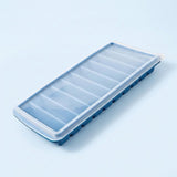 A rectangular ice cube tray with a clear plastic lid and blue silicone or rubber edges, shown on a light blue background.