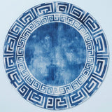 A round decorative plate or tray featuring a blue and white Greek key pattern border with a textured blue center, shown against a light blue background.
