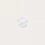 A small empty clear square organizer with smooth sides sits centered against an off-white background.