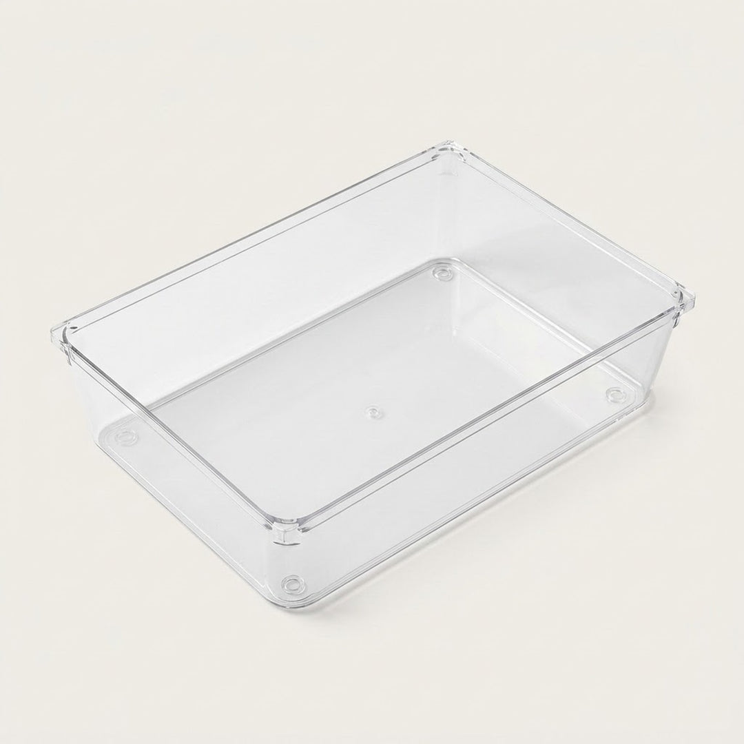 Clear rectangular organizer tray with smooth sides, a flat base, and rounded corners rests on an off-white background.