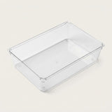Clear rectangular organizer tray with smooth sides, a flat base, and rounded corners rests on an off-white background.