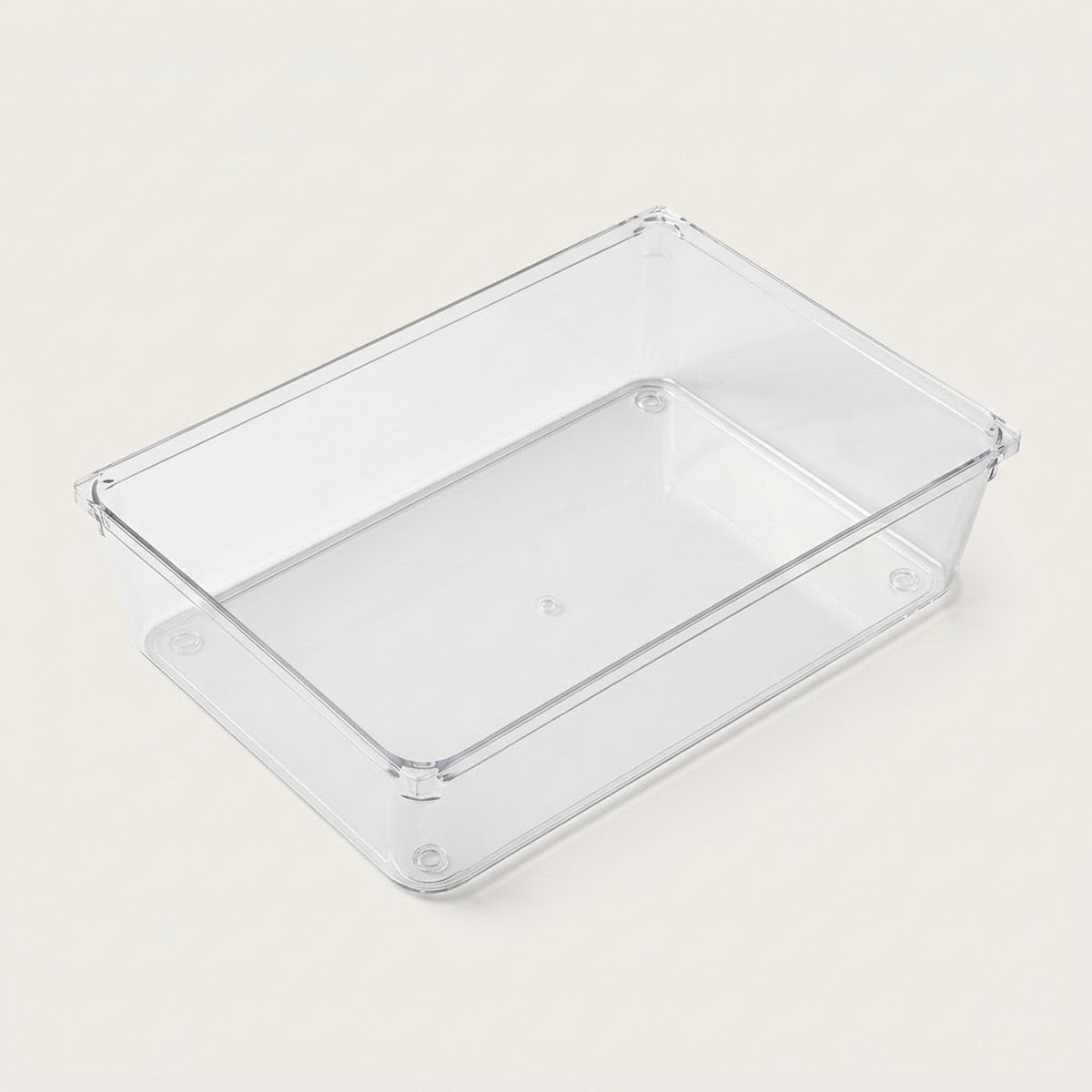 Clear rectangular organizer tray with smooth sides, a flat base, and rounded corners rests on an off-white background.