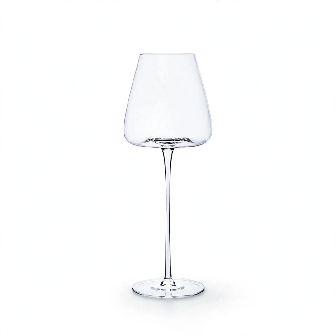 A single empty clear wine glass with a tapered bowl, slender stem, and round base stands against a white background.