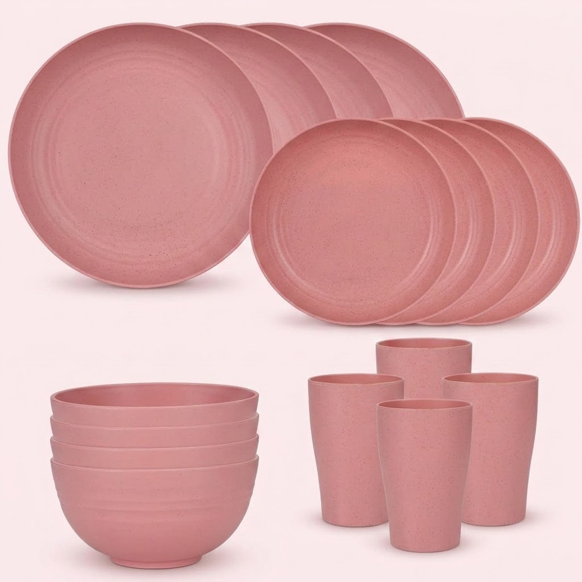 Pink dinnerware is arranged against a pale background with overlapping large and small plates, four stacked bowls, and four tall cups.