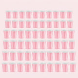 Sixty pink cups with white interiors are arranged in six rows of ten against a pale pink background.
