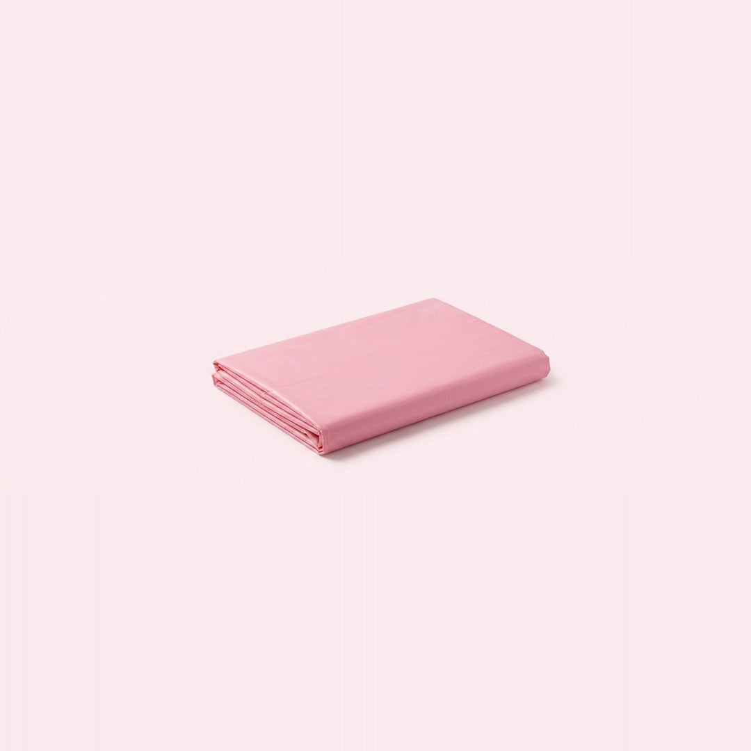 A folded pink sheet or fabric item shown on a plain pale pink background.