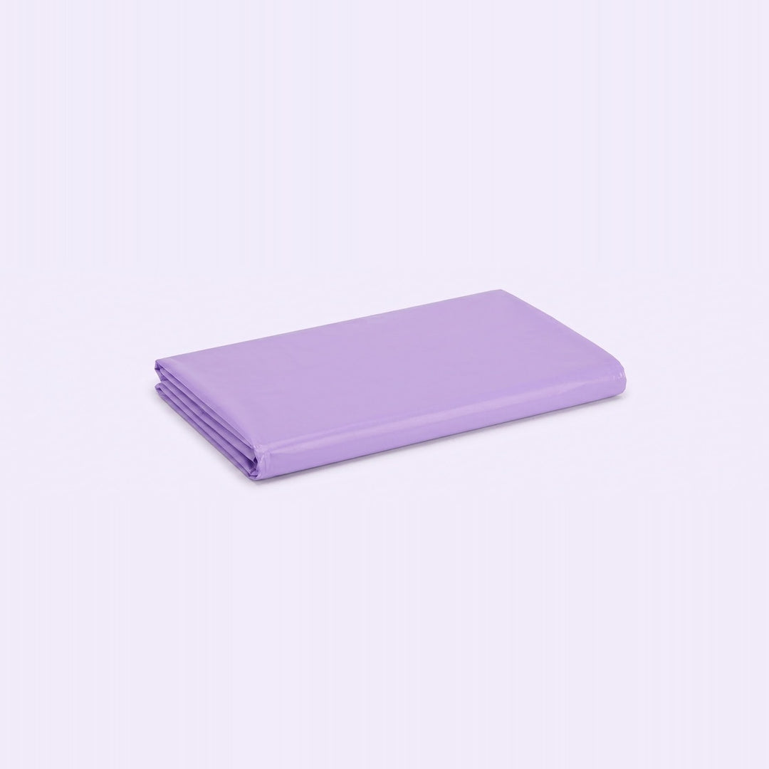 A folded sheet in a solid light purple or lavender color, displayed on a clean, light lavender-white background.