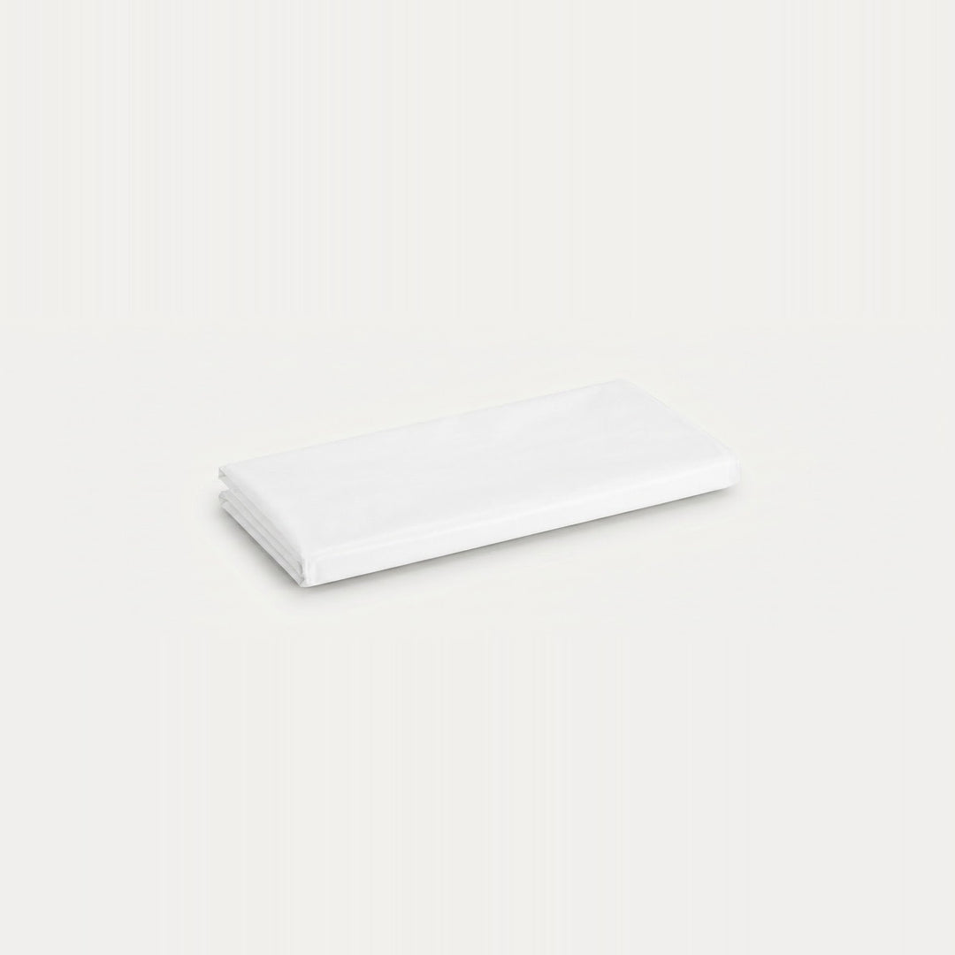 A folded white fabric item, likely a sheet or napkin, shown on a plain off-white background.