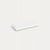 A folded white fabric item, likely a sheet or napkin, shown on a plain off-white background.