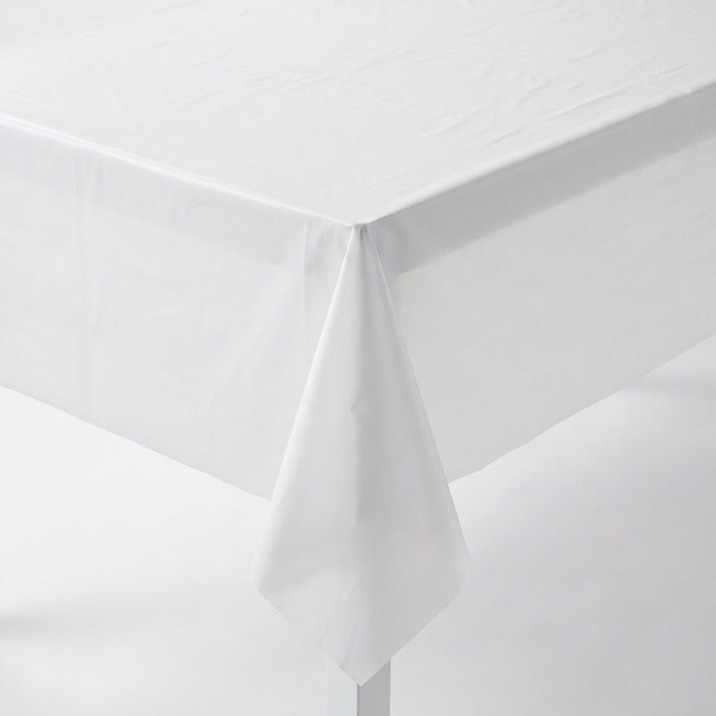 Close-up of a white plastic tablecloth draped over a rectangular table corner against a white background.