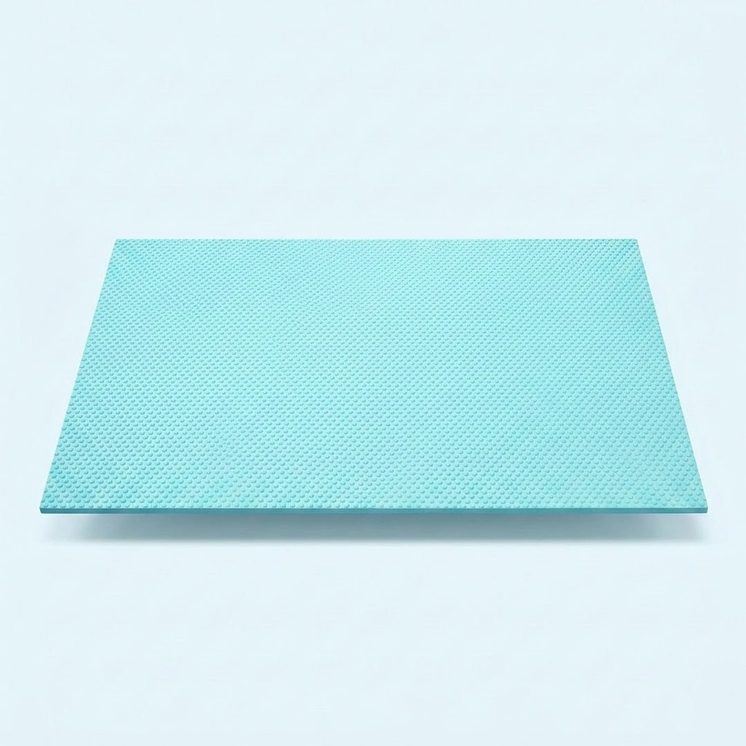 A square, light turquoise textured panel or mat shown from a top-down perspective on a clean, light gray background.