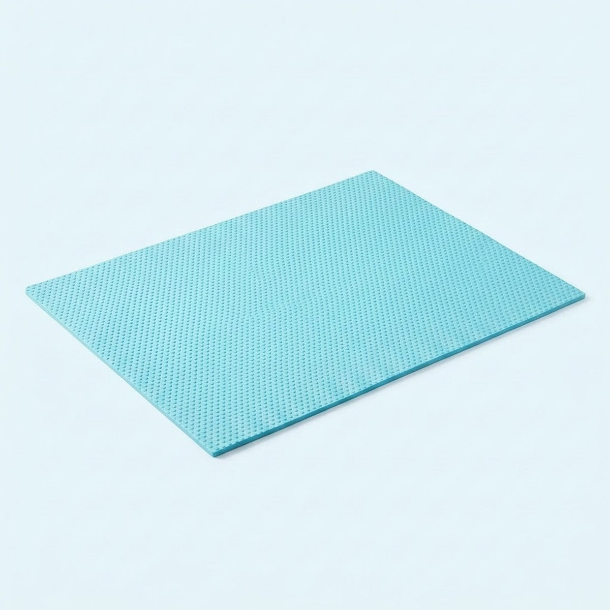A square light blue textured mat with a fine grid pattern, shown at an angle on a clean white background.