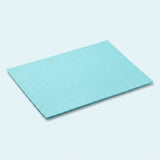 A rectangular light blue textured mat with a fine grid pattern, shown at an angle on a light blue background.