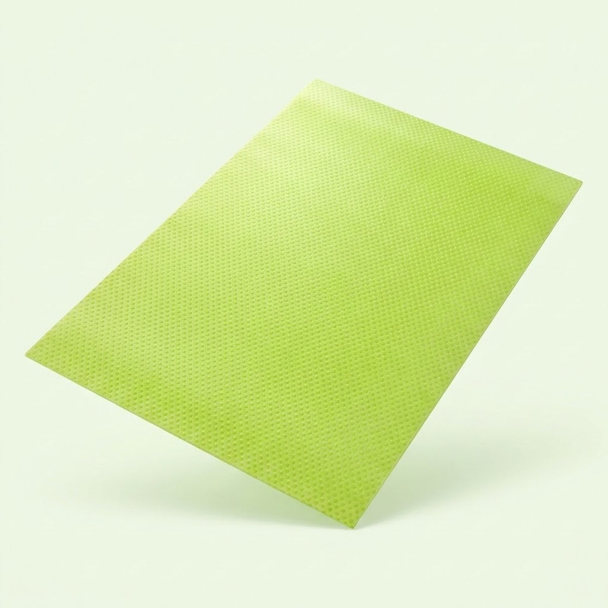 A lime green textured rectangular sheet or mat shown floating at an angle against a very light off-white background.