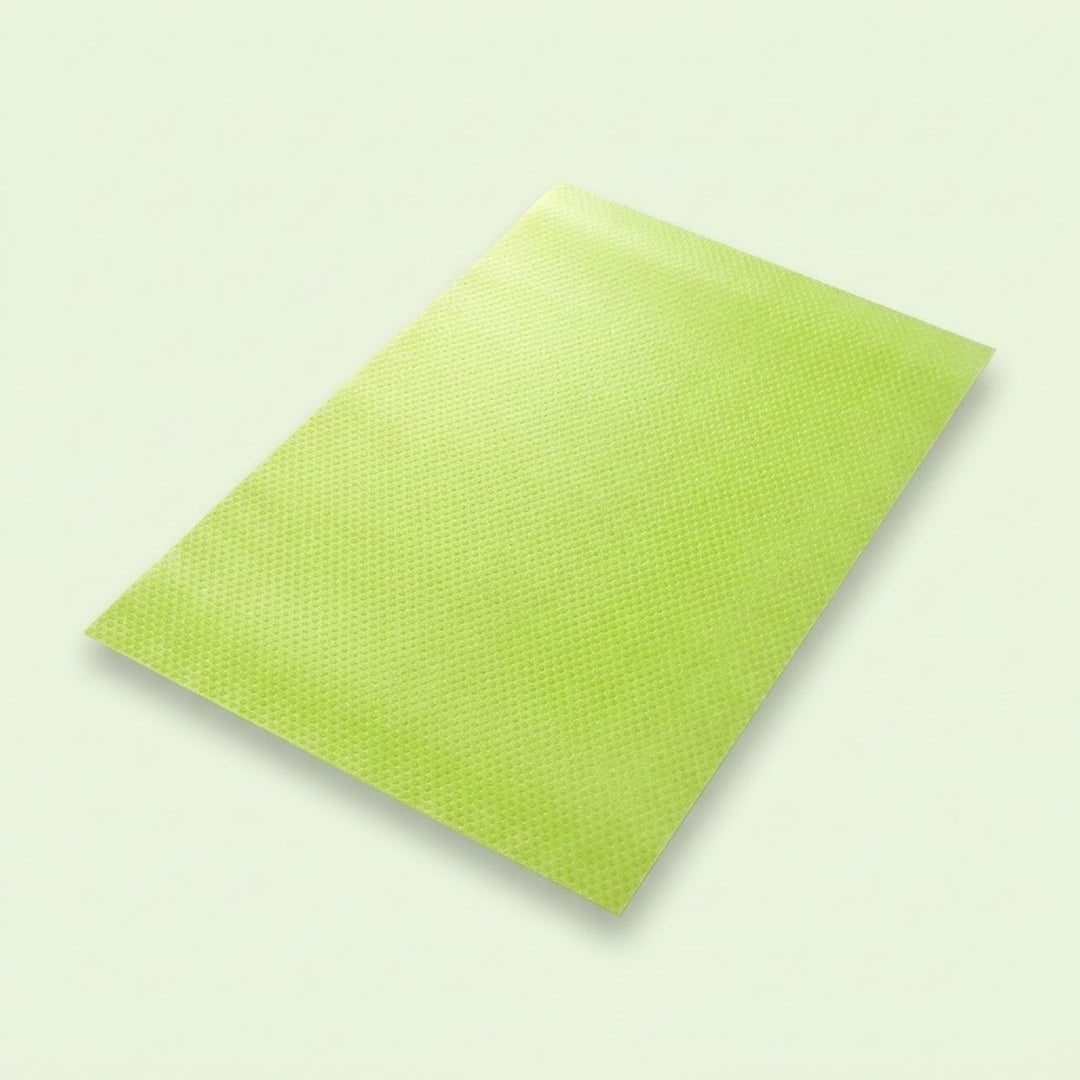 A lime green textured rectangular mat or pad shown at an angle on a light off-white background.