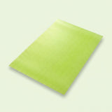 A lime green textured rectangular mat or pad shown at an angle on a light off-white background.