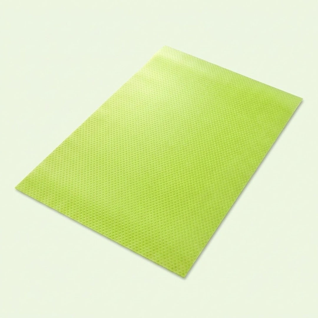 A lime green textured rectangular mat or pad shown at an angle on a light off-white background.