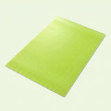 A lime green textured rectangular mat or pad shown at an angle on a light off-white background.
