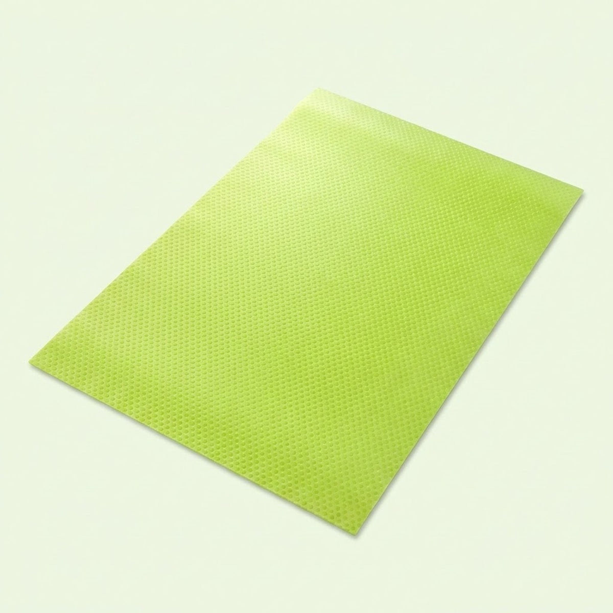 A lime green textured rectangular mat or pad shown at an angle on a light off-white background.