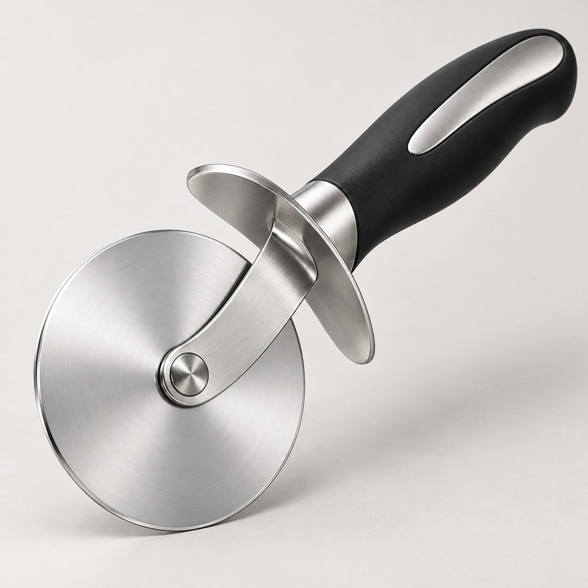 Pizza cutter wheel shown close up with its polished blade and protective finger guard.