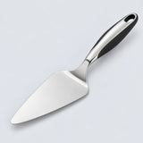Stainless steel pizza server with triangular blade and black handle on a pale studio background.