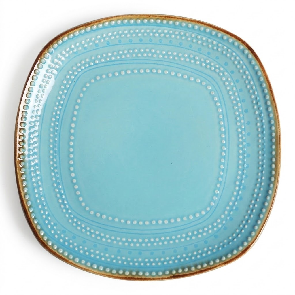 A square ceramic plate with rounded corners in light blue, decorated with concentric dotted patterns and a metallic gold rim, shown on a white background.