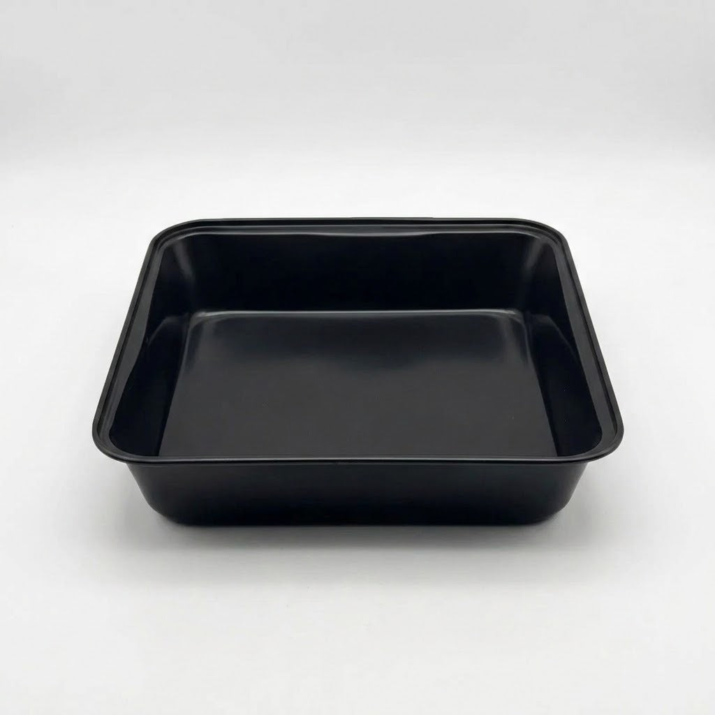 A black rectangular plastic tray with raised edges, photographed from above on a light gray studio background.