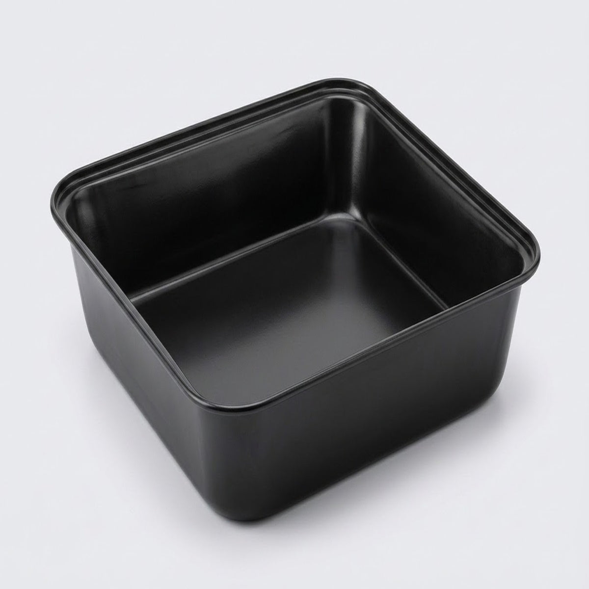 A square black non-stick baking pan with a low profile and raised rim, shown from an elevated perspective on a light gray background.