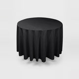 A round black tablecloth draped over a round table, shown against a light gray studio background.
