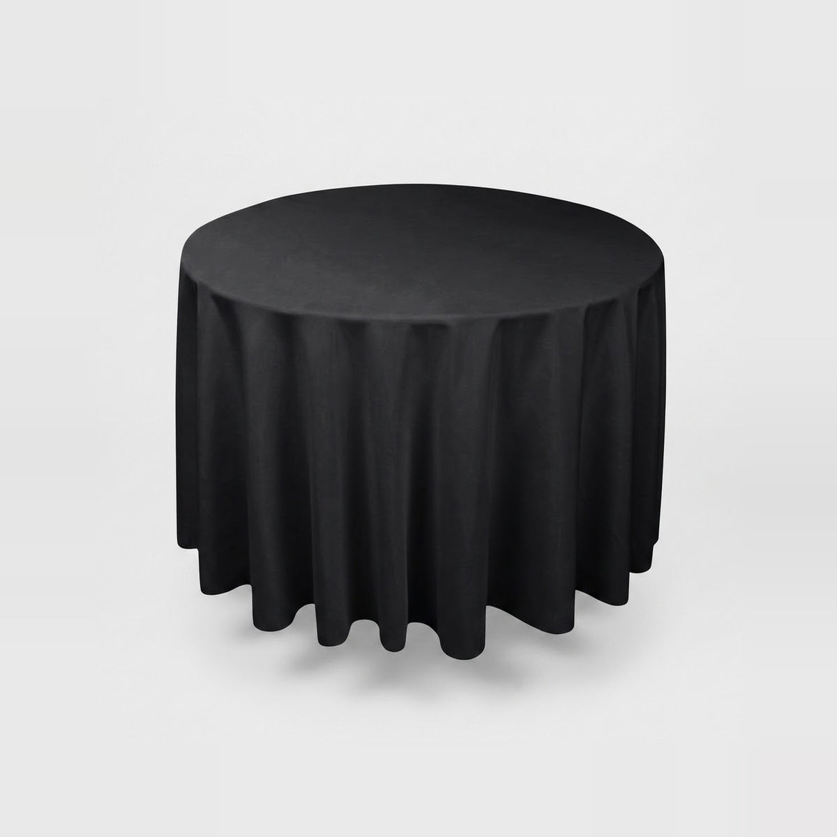 A round black tablecloth draped over a round table, shown against a light gray studio background.
