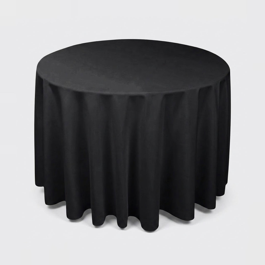 A round black tablecloth draped over a round table, shown against a plain light gray studio background.