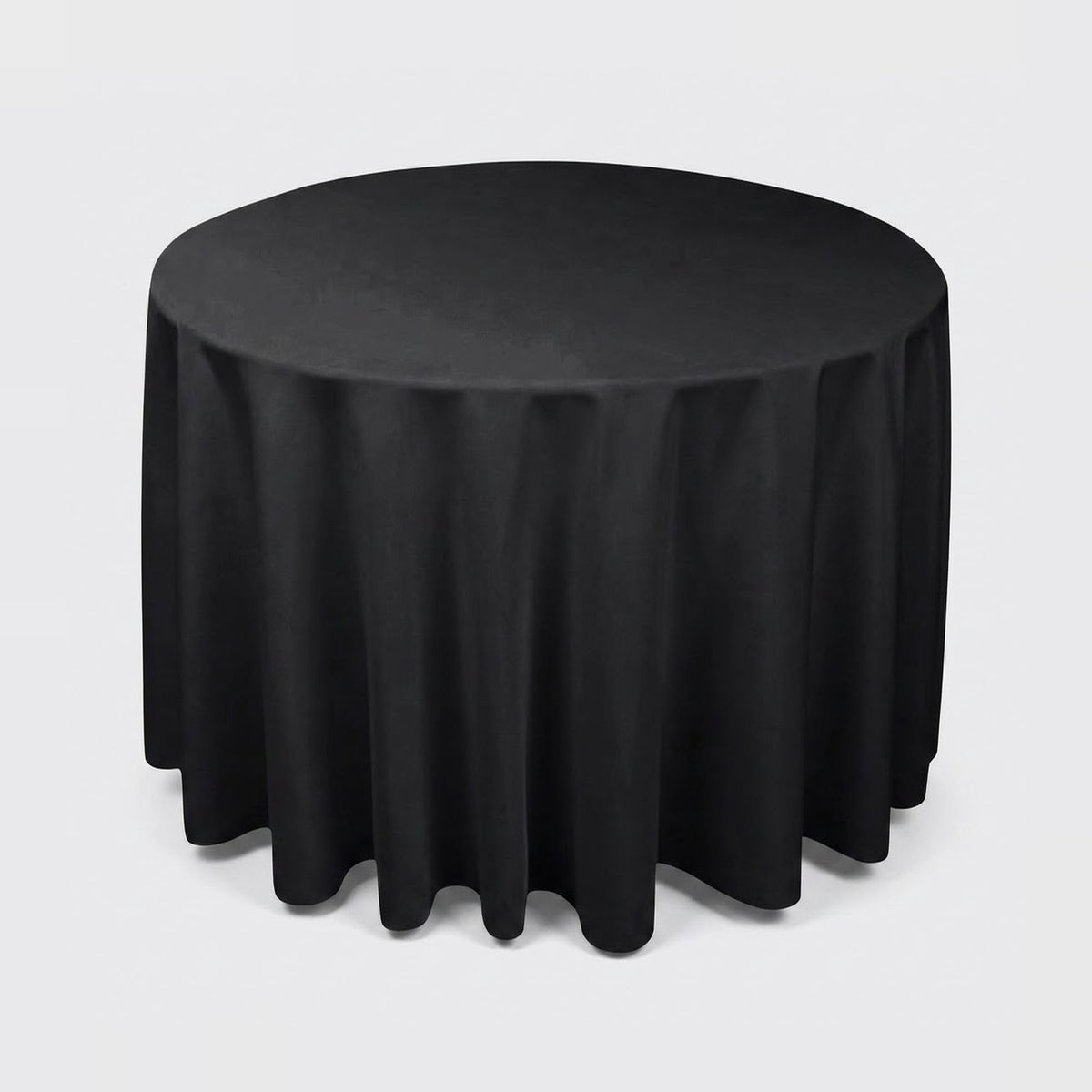 A round black tablecloth draped over a round table, shown against a plain light gray studio background.