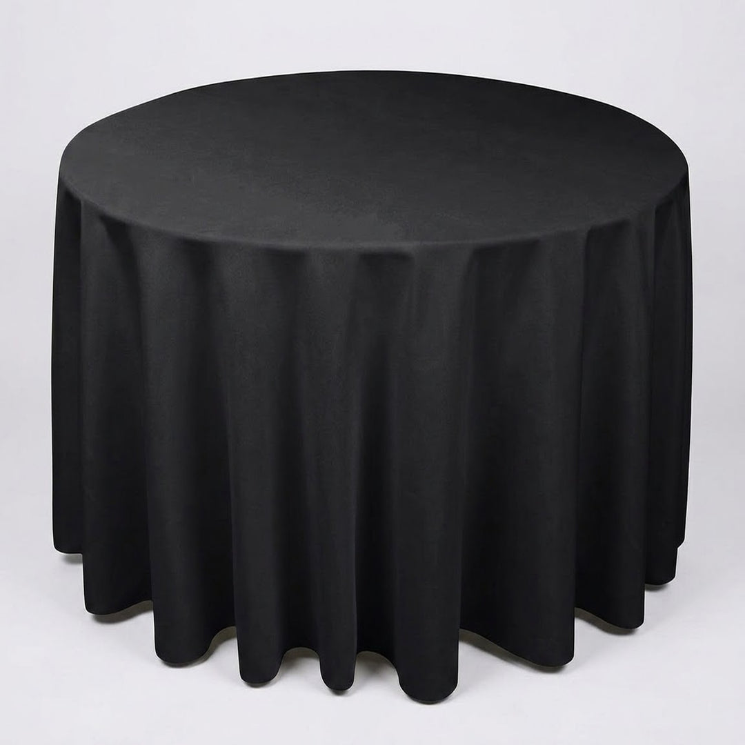 A round black tablecloth draped over a circular table, shown against a plain light gray studio background.