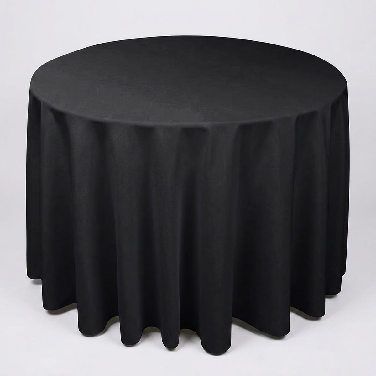A round black tablecloth draped over a circular table, shown against a plain light gray studio background.