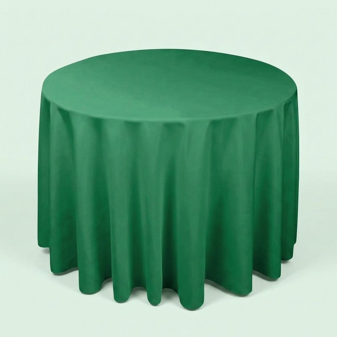 A round green tablecloth draped over a round table, shown against a plain light background.