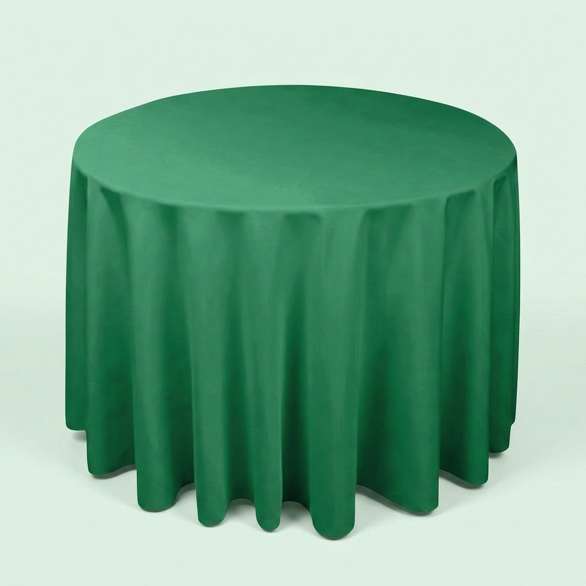 A round green tablecloth draped over a round table, shown against a plain light background.