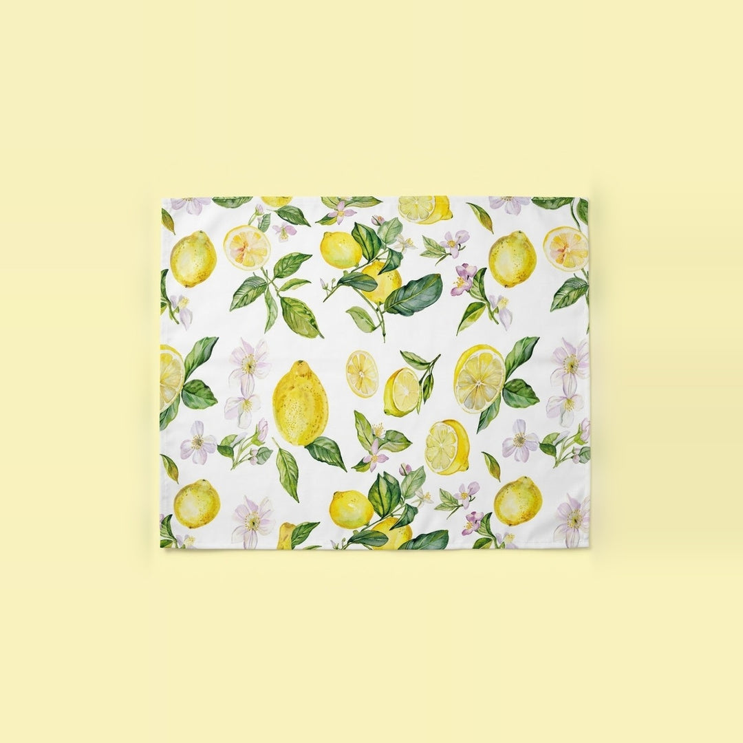 A square canvas print featuring a watercolor lemon and floral pattern on a white background, displayed against a solid pale yellow backdrop.