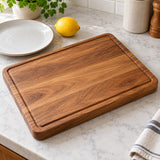 Wooden Kitchen Cutting Board sits beside a dinner plate and lemon to show its everyday scale.