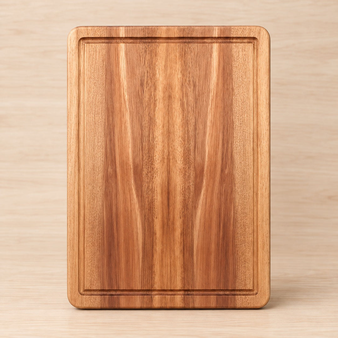 Small Wooden Kitchen Cutting Board shown alone on a pale warm studio backdrop.