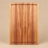Large Wooden Kitchen Cutting Board shown alone on a pale warm studio backdrop.