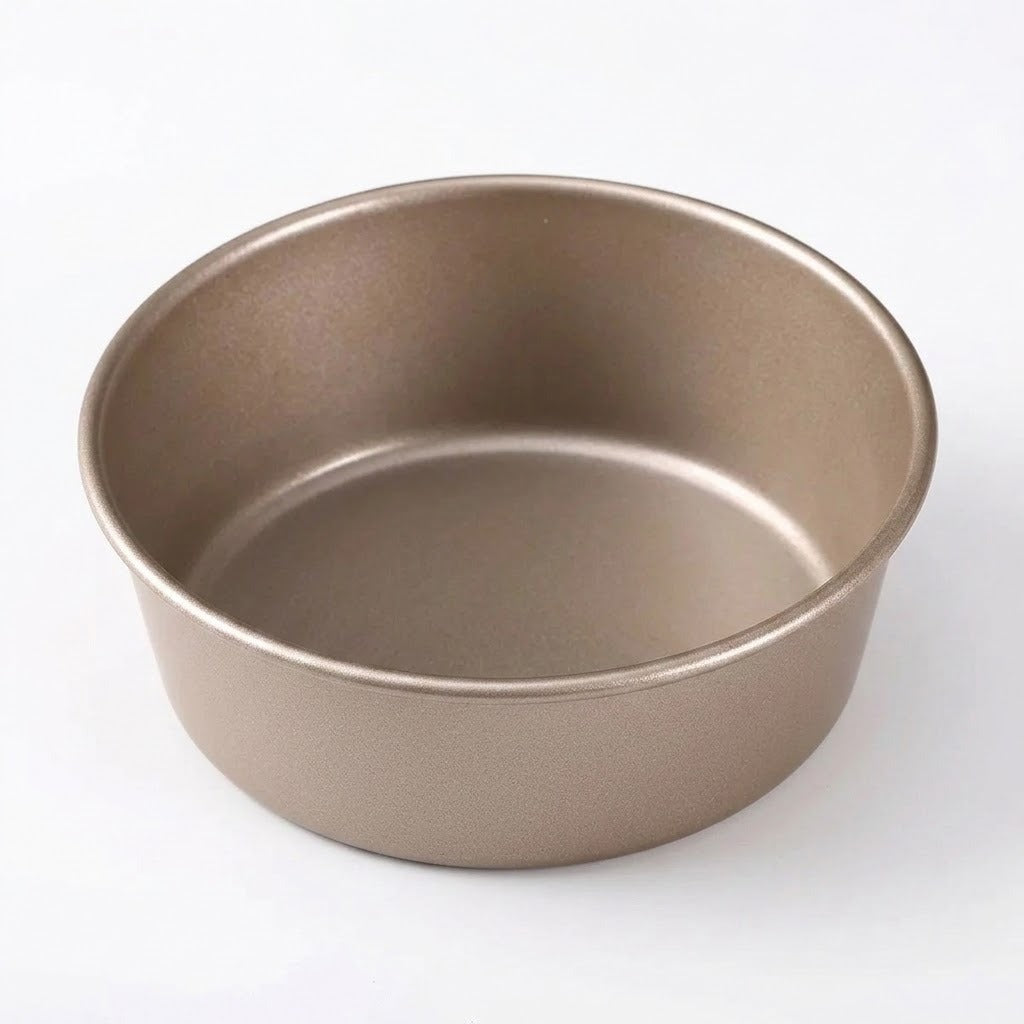 A round, shallow metal baking pan with a matte taupe finish, photographed from a high angle on a clean white background.