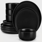 A set of matte black dinnerware, including plates and bowls, arranged on a clean white background.